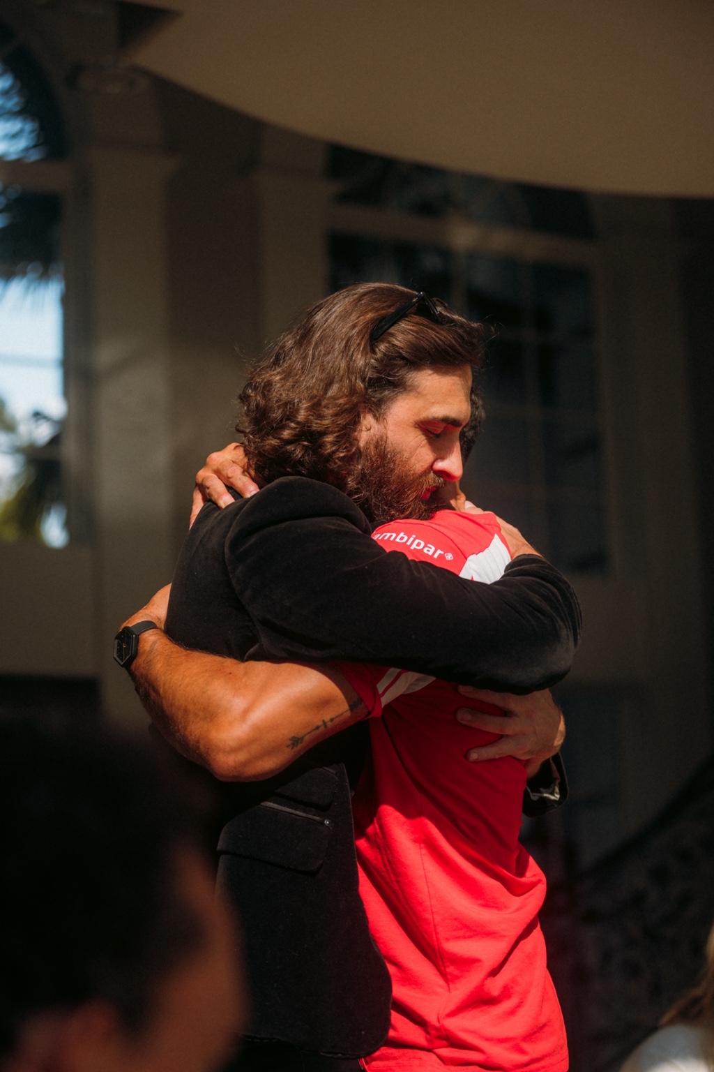 Two LCL brothers embracing during a gathering